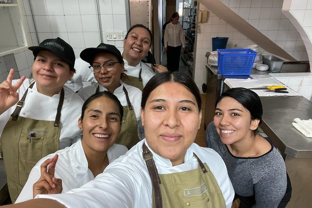 The team poses for a selfie in the Casa Román kitchen during the Spain Internship.