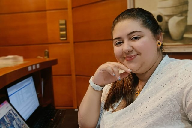 Lorena Torres sits in front of a laptop at Casa Román.