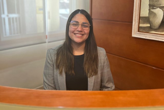 Patricia Larroza poses behind the reception desk at Casa Román.