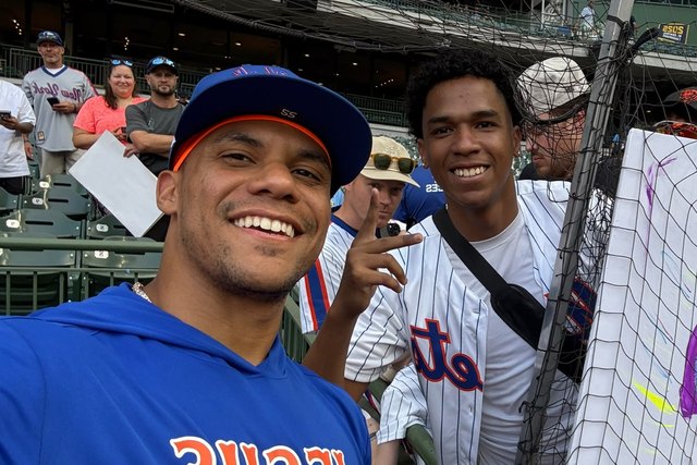 Two friends take a selfie in the stands at American Family Field.